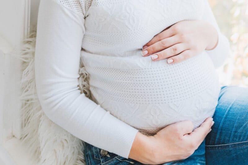 Woman cradling stomach