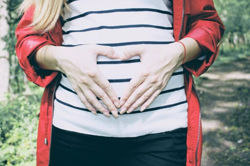 Pregnant woman holding stomach