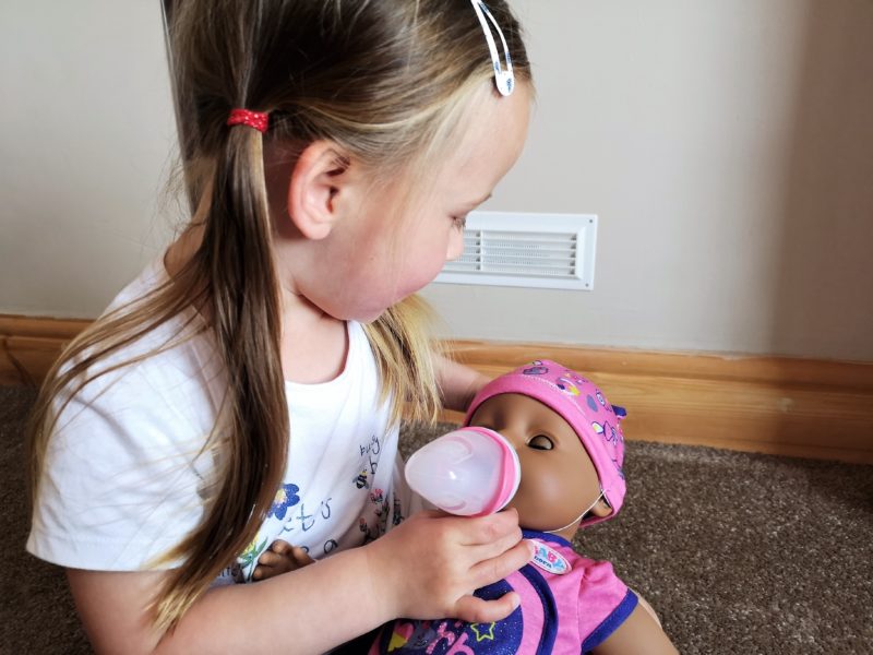 Erin giving the BABY born Soft Touch Doll a bottle