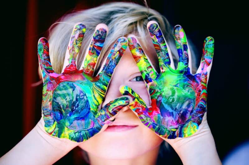 Child with colourful hands