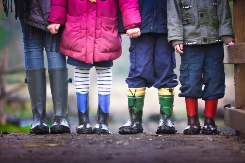 Children standing together in boots