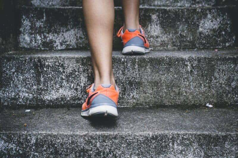 Woman running up steps