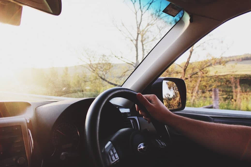 Hand on steering wheel in a car