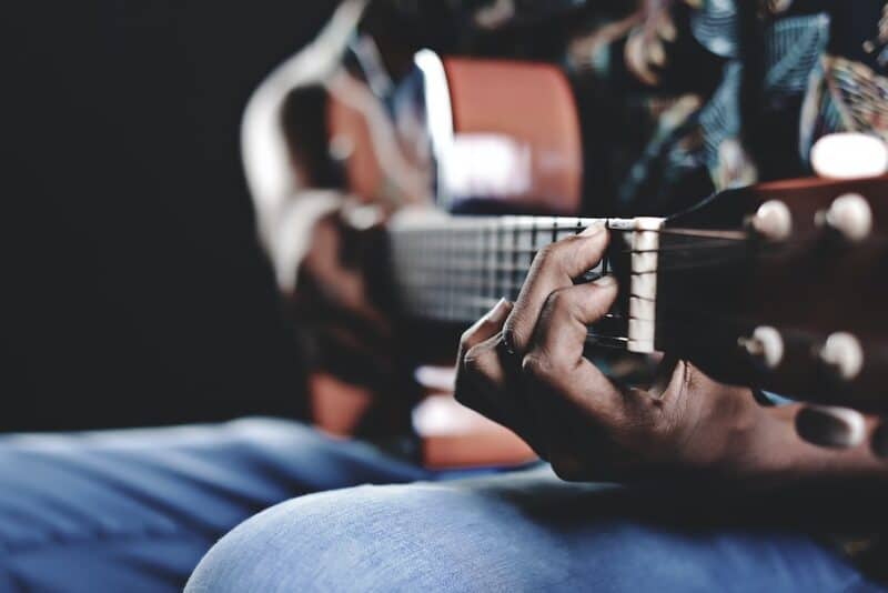Person playing a guitar