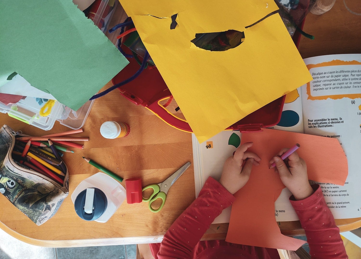 Child doing some art at a table