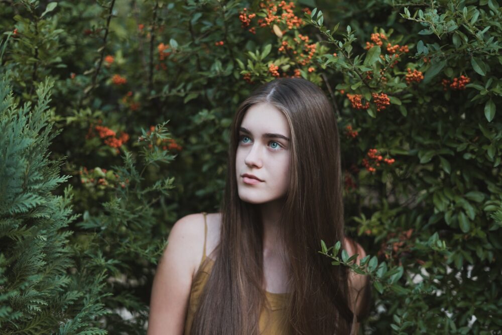 woman standing next to a tree