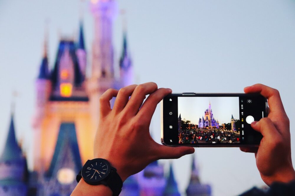 Person taking a picture of the Disney castle