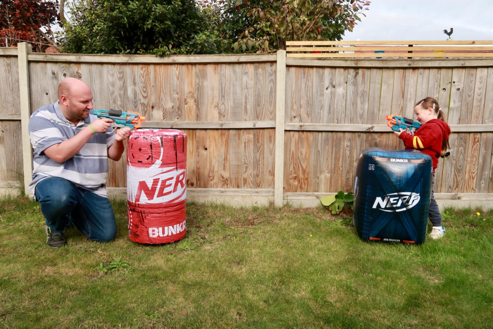 Erin and John playing with the Nerf BUNKR Toxic Barrel and Caution Crate