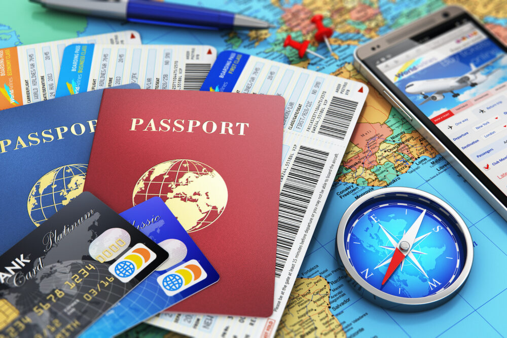 Passports, phone, travel cards and tickets on a map background