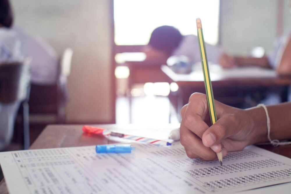 Close up on hand writing on an exam paper