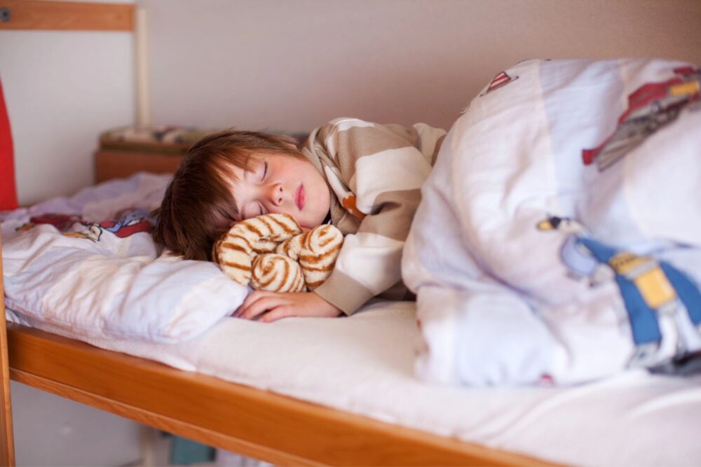 Boy Sleeping On Bunk Bed