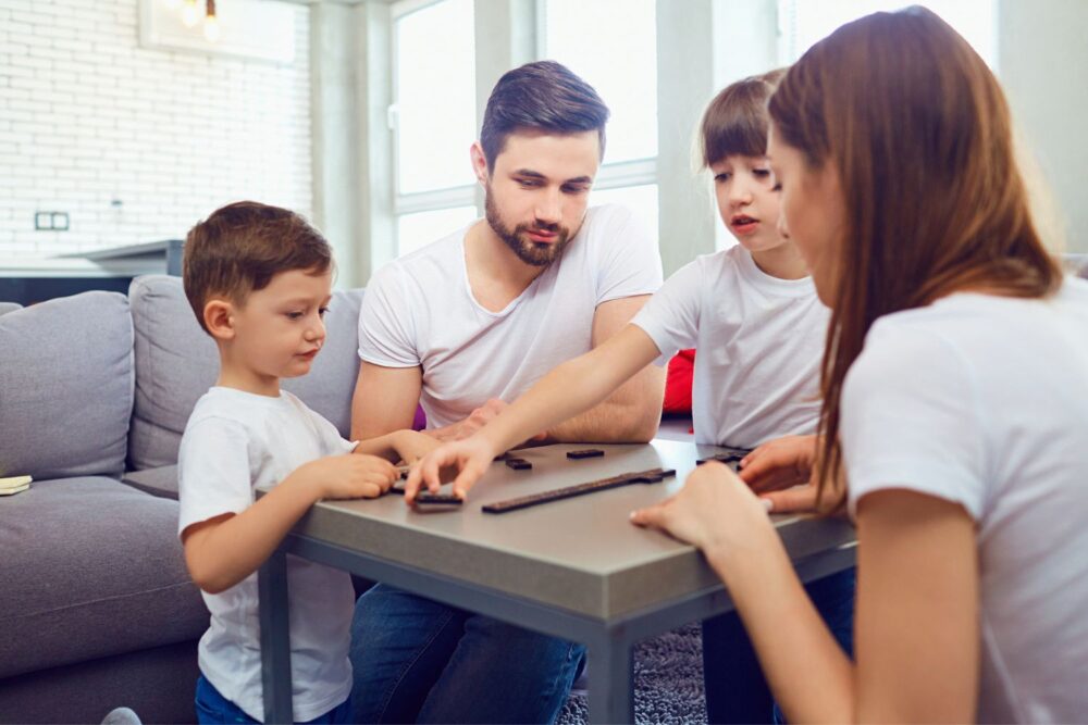 Happy family playing board games at home