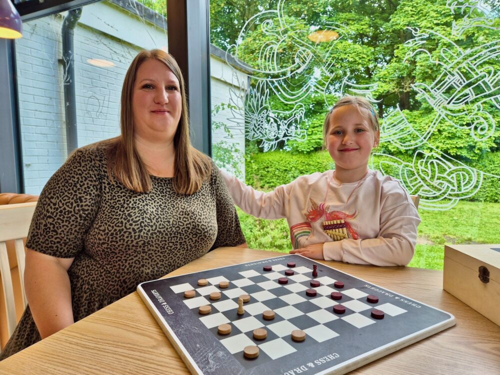 Mother and daughing playing draughts