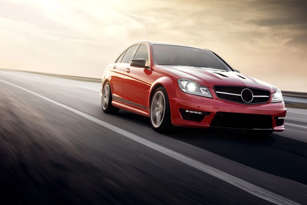 Red car driving on a road