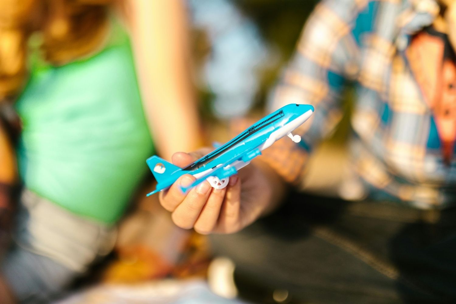 Close-Up Shot of a Person Holding an Airplane Toy