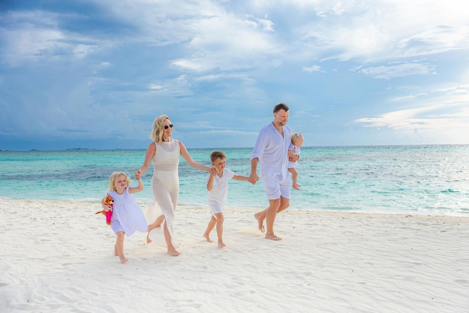 Happy Family Strolling on a Tropical Beach