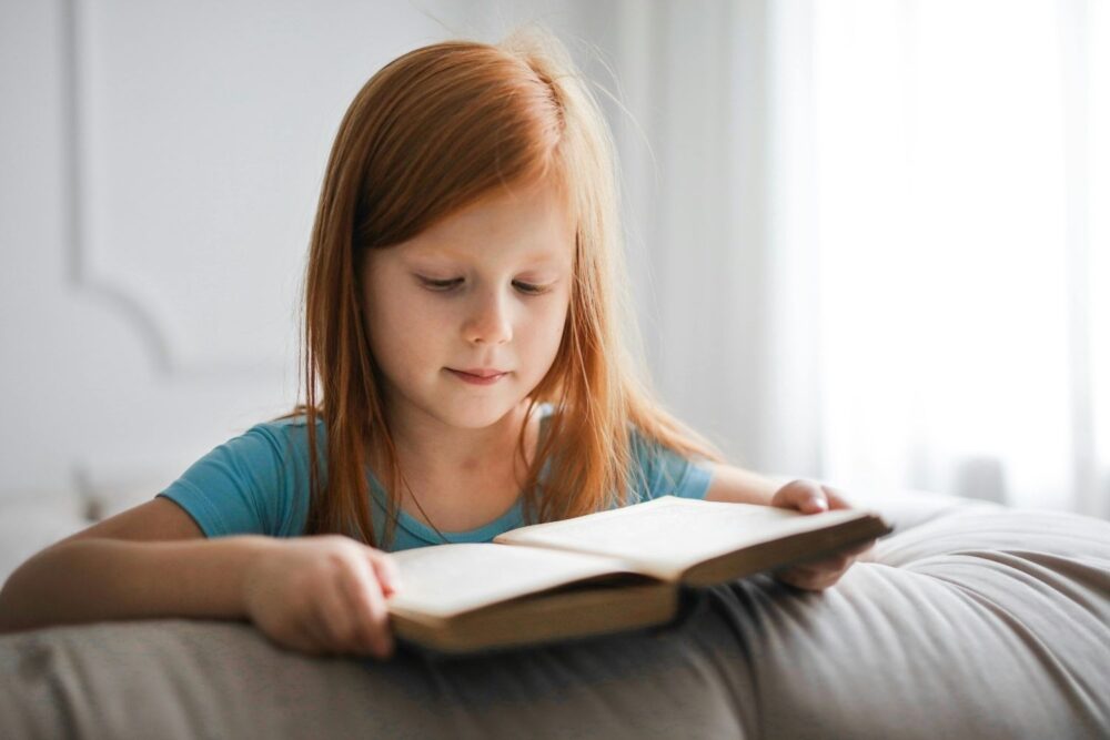 Girl in Blue T-shirt Reading Book