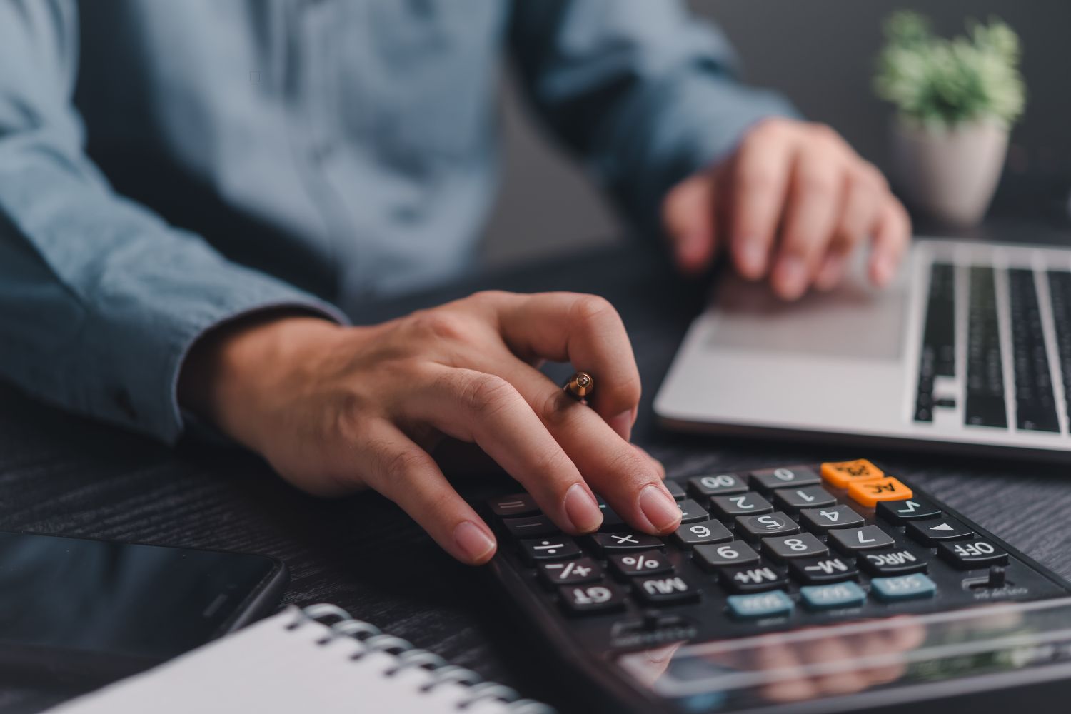 Businessman using calculator bookkeeping payroll and budget tax